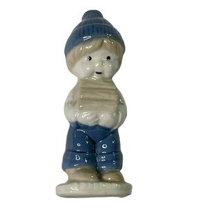 Charming Ceramic Figurine with Blue Accents carrying bundle of wood